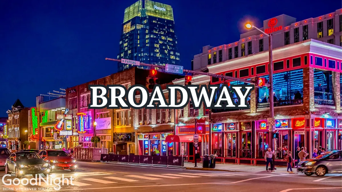 A bustling Nashville street scene at night, with neon signs lining the facades of honky tonks and live music venues, and crowds of people enjoying the energetic nightlife. High-rise buildings frame the view, emphasizing the downtown atmosphere.